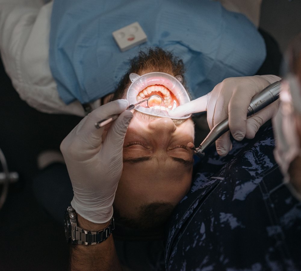 Patient and periodontist discussing jawbone imaging results in a treatment room