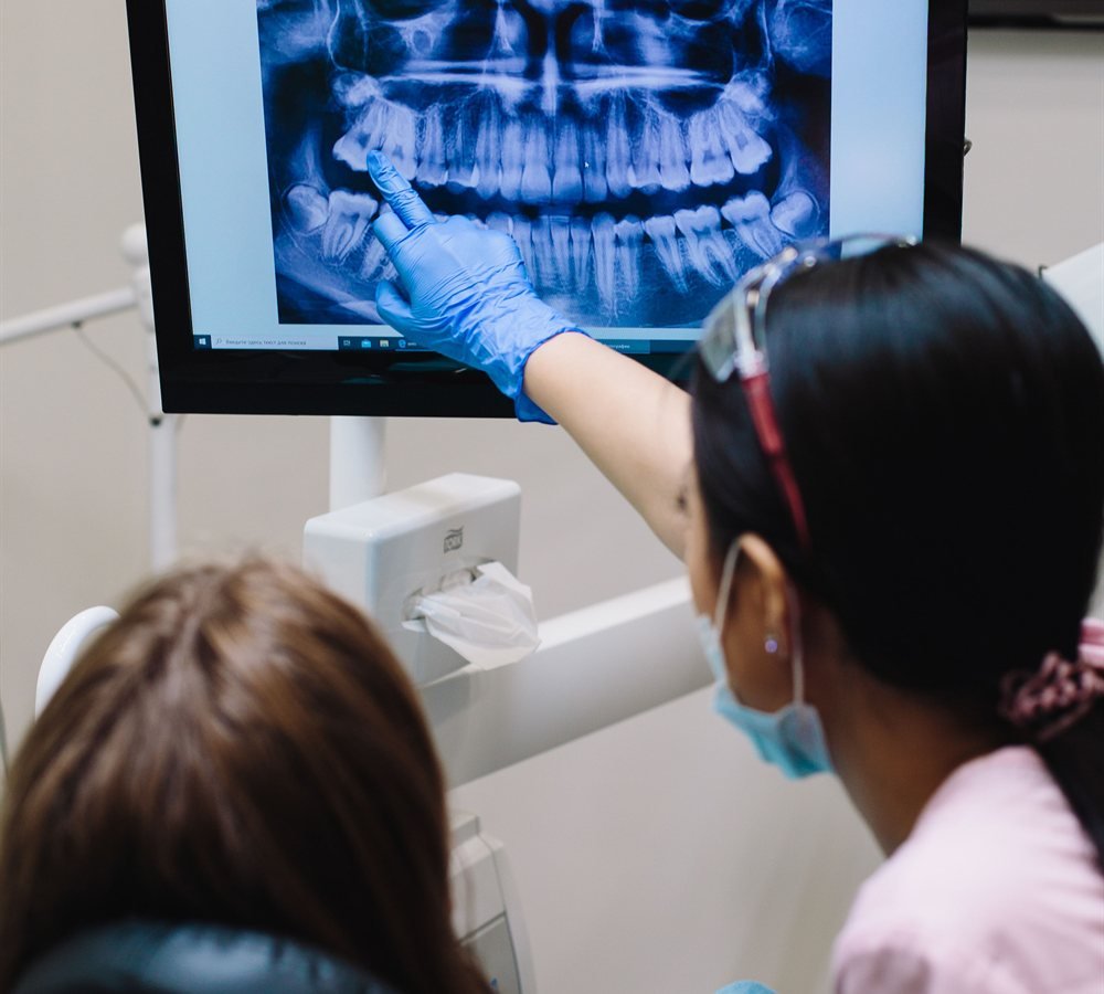 Periodontist reviewing 3D scan for a single tooth implant consultation